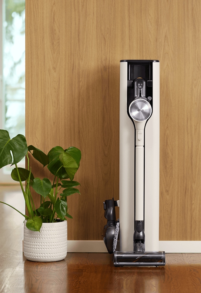 LG CordZero All-in-One Vacuum Tower Against the Wall of a Room Setting.