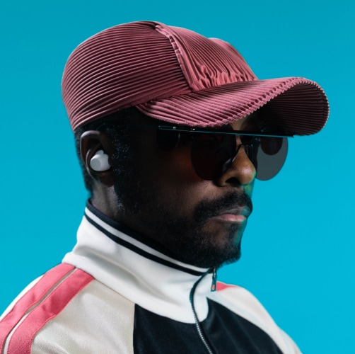 Will.i.am with xboom ear bud in his ear