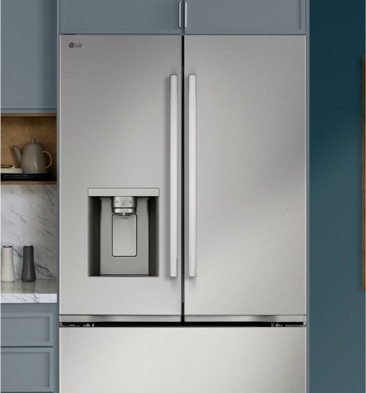 Front view of a stainless steel refrigerator with doors shut in a kitchen.