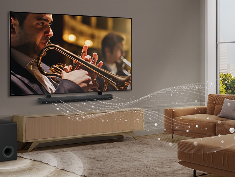 An LG Soundbar, LG TV, and subwoofer are in a modern city apartment. The LG Soundbar emits three branches of soundwaves, made of white droplets that float along the bottom of the floor. Next to the Soundbar is a subwoofer, creating a sound effect from the bottom. 